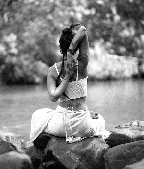 Woman in a calm, seated yoga pose, embodying inner harmony and balance.